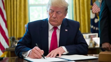 President Donald Trump signs an executive order to increase sanctions on Iran, in the Oval Office of the White House, Monday, June 24, 2019, in Washington. US Iran Trump