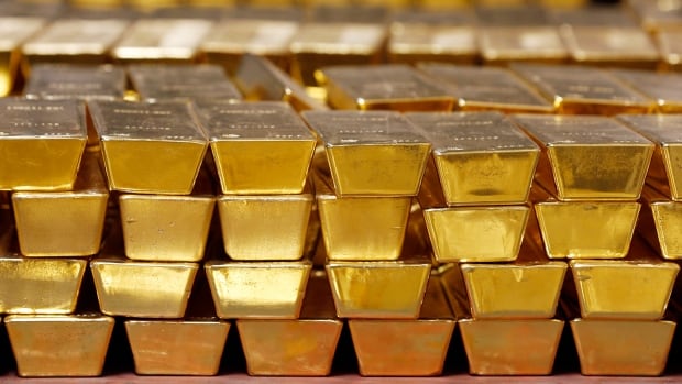 FILE - In this Tuesday, July 22, 2014, file photo, gold bars are stacked in a vault at the United States Mint, in West Point, N.Y. The price of gold has climbed recently as investors scramble for safety amid the widening global trade war. It’s up nearly 5% since May 21, 2019, as stock markets around the world fell, and last week was the best of the year for gold after President Donald Trump surprised markets by threatening to raise tariffs on Mexico. (AP Photo/Mike Groll, File)