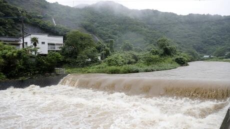 The Futami River is swollen due to heavy rain in Yatsushiro, Kumamoto Prefecture, southwestern Japan, July 3, 2019, in this photo taken by Kyodo. Mandatory credit Kyodo/via REUTERS ATTENTION EDITORS - THIS IMAGE WAS PROVIDED BY A THIRD PARTY. MANDATORY CREDIT. JAPAN OUT. NO COMMERCIAL OR EDITORIAL SALES IN JAPAN. - RC14270C5A20 JAPAN-WEATHER/
