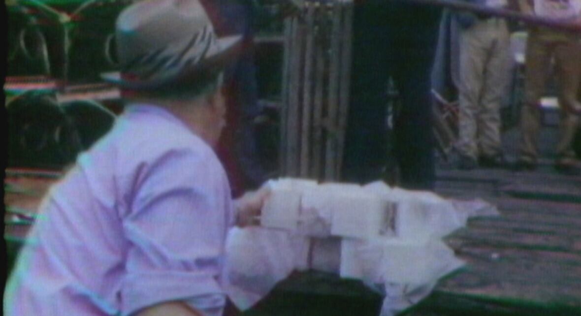 Man pulling large white cubes off ship