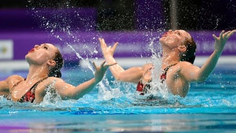 Claudia Holzner and Jacqueline Simoneau of Canada perform in the synchronized swimming duet of FINA Artistic Swimming World Series Super Final in Duna Arena in Budapest, Hungary, Friday, June 14, 2019. (Tibor Illyes/MTI via AP) synchro-swimming