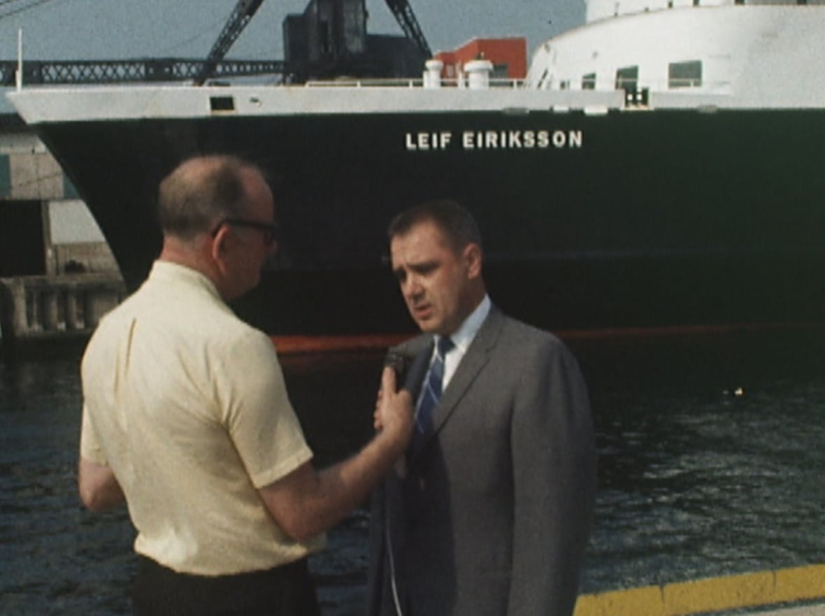 Reporter with microphone talking to man