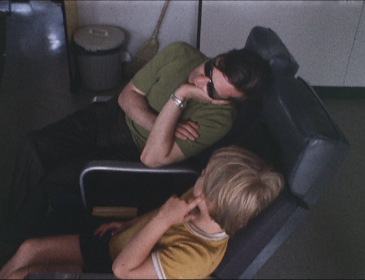 Adult and child slumped over in chairs