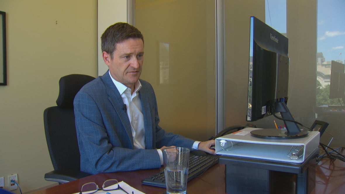 Ian Jack sitting at a desk. 