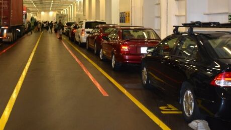 Cars sit inside a BC Ferries vessel on June 26, 2015. Delta police say a man has been arrested on suspicion of mischief for allegedly keying a number of cars earlier this month because their car alarms were bugging his dog. bc ferries cars