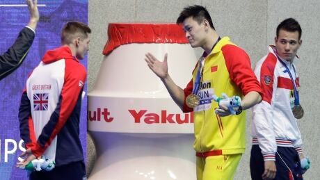 Gold medallist Sun Yang, centre, gestures to Britain's bronze medallist Duncan Scott, left, following the medal ceremony in the men's 200-metre freestyle final at last month's world swimming championships in Gwangju, South Korea. sun-scott-072519