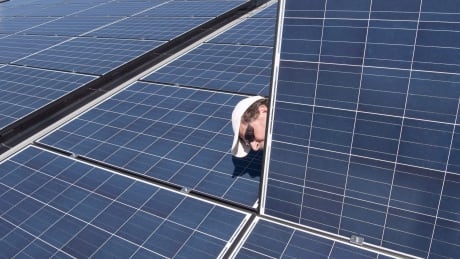 Jason Andriulaitis checks a connection under a new solar panel installation in Scugog, Ont., on Wednesday, April 27, 2016. Solar Panels Economics 20181128