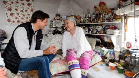 Prime Minister Justin Trudeau talks with Inuit elder Qaapik Attagutsiak, 99, in her tiny home during a visit to Arctic Bay, Nvt., on Thursday, Aug. 1, 2019. Sitting on a bed next to the oldest Inuit woman in northern Nunavut, Prime Minister Justin Trudeau heard and witnessed first-hand what life is like for the people of the Far North. Trudeau North 20190801