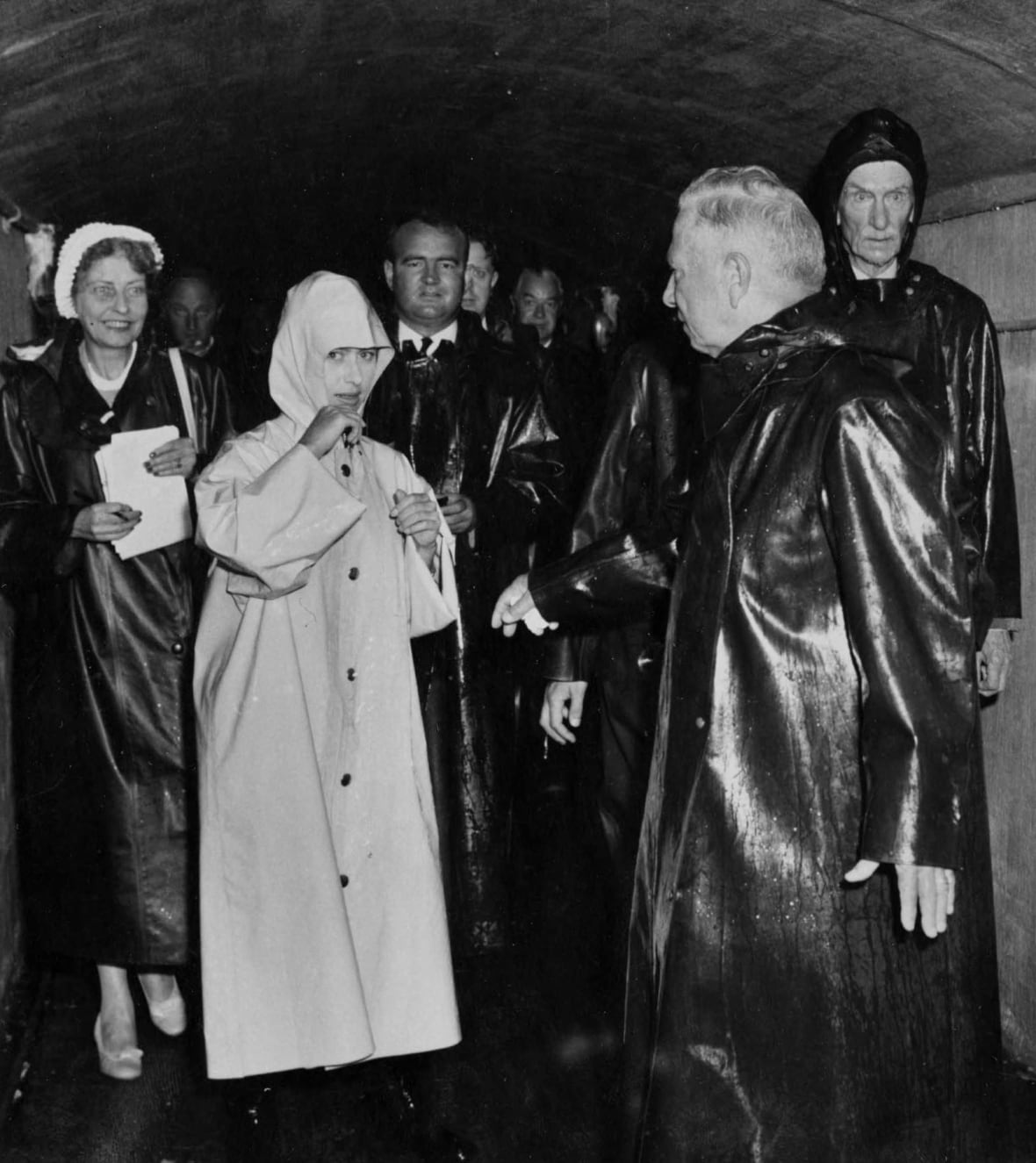People wearing heavy raincoats