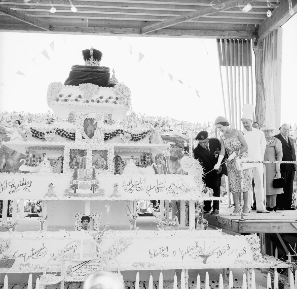 woman cutting into extremely large cake