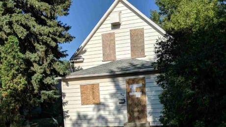 boarded up home on Avenue V S
