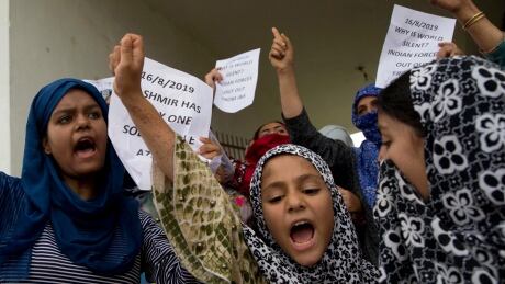 Kashmiri Muslim girls shout pro-freedom slogans during a demonstration after Friday prayers amid curfew-like restrictions in Srinagar, India, on Friday.
India Kashmir
