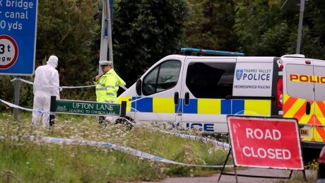 A police investigator at the scene of an incident where a police officer was killed, near Sulhamstead, England on Friday. Ten males have been arrested and are in custody, including a 13-year-old. Britain Police