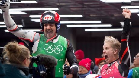 Canadian luger Sam Edney and teammate Alex Gough celebrate the moment of a silver win in the team luge event at the 2018 Olympics. Luge Redemption for Sam Edney
