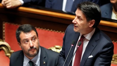 Italian Prime Minister Giuseppe Conte, next to Italian Deputy PM Matteo Salvini, addresses the upper house of parliament over the ongoing government crisis, in Rome. Italian Prime Minister Giuseppe Conte