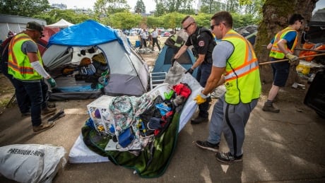 Vancouver Fire officers and Park Board officials take away mattresses while checking on vacant tents at Oppenheimer Park in Vancouver, British Columbia on Tuesday, August 20, 2019. OPPENHEIMER PARK DTES TENT CITY