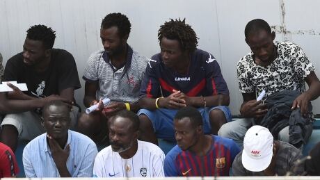 Migrants, some of whom disembarked from Spanish rescue ship Open Arms NGO, are seen at the immigration centre on the southern Sicilian island of Lampedusa, Italy on Wednesday. Spain, France, Germany, Luxembourg and Portugal have agreed to process the migrants from Open Arms. EUROPE-MIGRANTS/ITALY-SPAIN