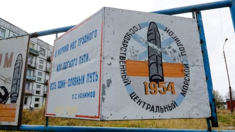 A billboard reads "The State Central Navy Testing Range" near residential buildings in the village of Nyonoksa, northwestern Russia, where an explosion of a rocket engine at the Russian navy's testing range led to a brief spike in radiation levels. Russia Rocket Explosion Mystery