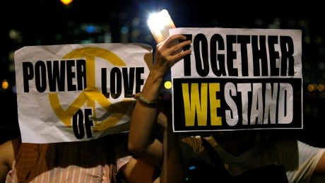 Protesters hold placards as they form a human chain during a rally to call for political reforms along Tsim Sha Tsui and Hung Hom Promenade in Hong Kong, China, August 23, 2019. HONGKONG-PROTESTS/HUMANCHAIN