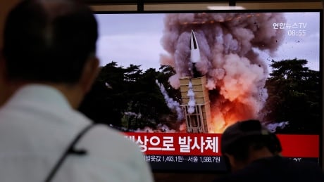 People watch a TV news program reporting North Korea's firing projectiles with a file image at the Seoul Railway Station in Seoul, South Korea, Saturday, Aug. 24, 2019. North Korea fired two suspected short-range ballistic missiles off its east coast on Saturday in the seventh consecutive week of weapons tests, South Korea’s military said, a day after it threatened to remain America’s biggest threat in protest of U.S.-led sanctions on the country. The part of Korean letters read: "Projectiles." South Korea North Korea Projectiles