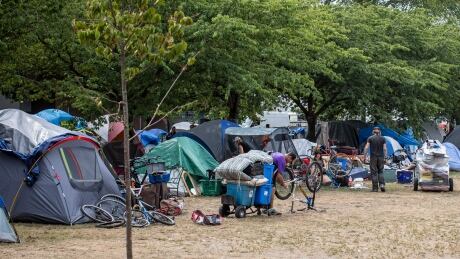 Vancouver fire and park board officials take away mattresses while checking on vacant tents at Oppenheimer Park in Vancouver, British Columbia on Tuesday, Aug. 20, 2019. (Ben Nelms/CBC) OPPENHEIMER PARK DTES TENT CITY