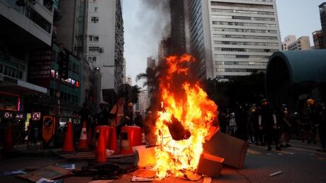 A fire set by protesters burns at an entrance to the Wan Chai MTR subway station in Hong Kong, Sunday, Sept. 15, 2019. Police fired a water cannon and tear gas at protesters who lobbed Molotov cocktails outside the Hong Kong government office complex Sunday, as violence flared anew after thousands of pro-democracy supporters marched through downtown in defiance of a police ban. (AP Photo/Kin Cheung) Hong Kong Protests