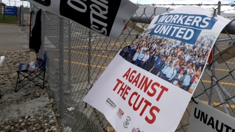 UAW picket signs stick in the fence in front of the General Motors Flint Assembly plant in Flint, Michigan Sept. 15, 2019. The United Auto Workers union announced Sunday that its workers at GM plants in the U.S. would go on strike just before midnight because contentious talks on a new contract had broken down. UAW Strike Threat