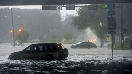Stalled cars sit among flooded Calder Avenue near I-10 in Beaumont, Texas, where several roads remained heavily flooded throughout the afternoon on Thursday, Sept. 19, 2019. Boaters and other emergency personnel were conducting rescue missions to those in need throughout the morning and afternoon. Tropical Weather Gulf