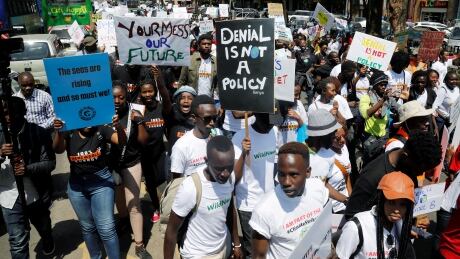 Environmental activists hold signs as they take part in the protest calling for action on climate change in Nairobi, Kenya. climate change kenya