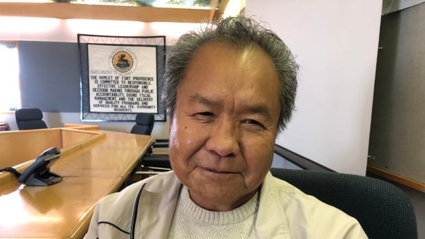 A head shot of an elder smiling at the camera.