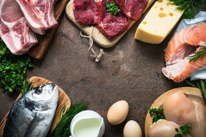 Fish and red meat are seen on platters scattered in a circle. 