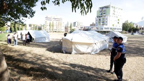 Police officers are seen near tents at a temporary shelter after an earthquake in Tirana, Albania, September 22, 2019. REUTERS/Florion Goga - RC14A9E830A0 ALBANIA-QUAKE/