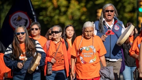 People march in remembrance of residential school victims and survivors on Commercial Drive in Vancouver, British Columbia on Monday, Sept. 30, 2019. In all, about 150,000 First Nation, Inuit and Métis children were removed from their communities and forced to attend the schools. ORANGE SHIRT DAY