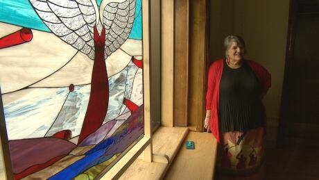 Patty Musgrave Quinn, the Indigenous affairs co-ordinator at Mount Allison University, stands next to Pauline Young's new stained glass work commemorating missing and murdered Indigenous women and girls. MMIWG Art Pauline Young