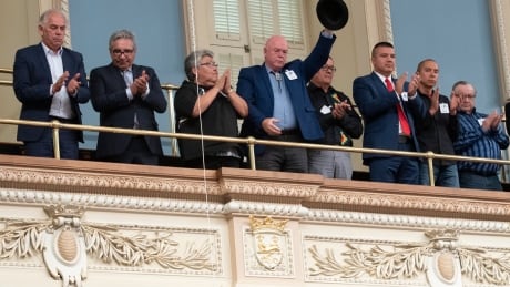 Huron Wendat grand chief Konrad Sioui raises his hat while members of the National Assembly applaud after Quebec Premier Francois Legault apologized to First Nations and Inuit leaders during a declaration at the legislature in Quebec City Wednesday, Oct. 2, 2019. Que Indigenous Apology 20191002