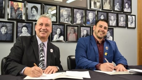 UNBC President Dr. Daniel Weeks and Lheidli T’enneh Nation chief Clay Pountney sign an agreement for members of the Lheidli T’enneh Nation to attend UNBC at no cost to the student. UNBC tuition