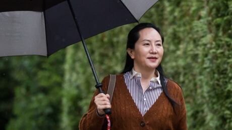 Huawei chief financial officer Meng Wanzhou leaves for court during a light rain in Vancouver on Oct. 3. She faces possible extradition to the United States. Meng Wanzhou