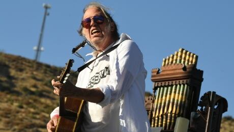 Neil Young performs at Harvest Moon: A Gathering to benefit The Painted Turtle and The Bridge School at Painted Turtle Camp in Lake Hughes, California, in 2019. Neil Young