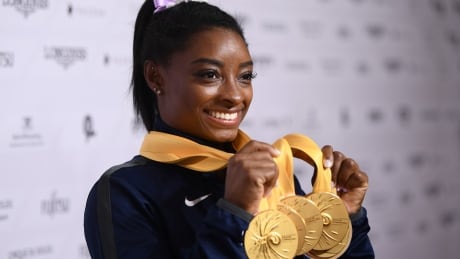 Simone Biles poses with her five gold medals at the artistic gymnastics world champions on Sunday in Stuttgart, Germany. A repeat performance at Tokyo 2020 would make her the first female gymnast to ever top the podium five times at one Olympics. biles-simone-101419