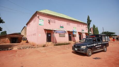A police vehicle drives past the Daru Imam Ahmed Bun Hambal Islamic school, another school in Nigeria where 300 students were found chained up in September. NIGERIA-CAPTIVE/RESCUE