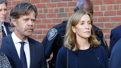 Actress Felicity Huffman leaves the federal courthouse on with her husband William H. Macy on Sept. 13, 2019, after being sentenced in connection with a nationwide college admissions cheating scheme. Huffman began serving her two week sentence on Tuesday. USA-EDUCATION/CHEATING