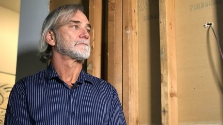 Wayne Morrissey stands in front of a damaged wall in his home in Vancouver, B.C. Wayne-Morrissey-Damaged-Wall