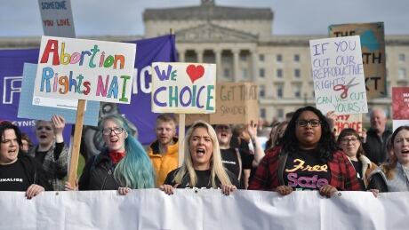 Abortion-rights demonstrators march through the streets of Belfast ahead of a meeting of the Stormont Assembly on abortion rights and gay marriage on Monday. Northern Ireland's laws banning abortion and gay marriage were liberalized midnight. 1177312765