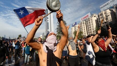Demonstrators display flags and banners during a protest against President Sebastian Pinera on Tuesday in Santiago, Chile. Protests had begun on Friday and developed into looting and arson, generating chaos in Santiago, Valparaiso and a dozen other cities resulting in at least 11 dead. 1177498553