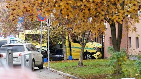 A damaged ambulance stands next to a building after an armed man who stole the vehicle was apprehended by police in Oslo on Tuesday. NORWAY-AMBULANCE/