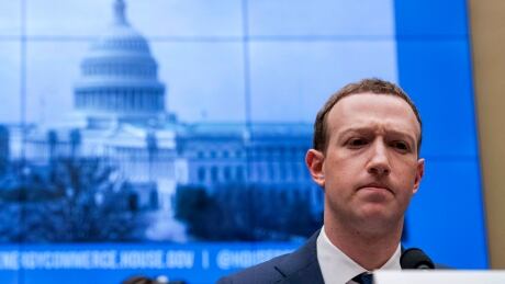 FILE - In this April 11, 2018, file photo, Facebook CEO Mark Zuckerberg pauses while testifying before a House Energy and Commerce hearing on Capitol Hill in Washington about the use of Facebook data to target American voters in the 2016 election and data privacy. Zuckerberg plans to tell Congress Wednesday, Oct. 23, 2019, that the company’s planned Libra cryptocurrency won’t launch unless all U.S. regulators approve. Facebook Libra