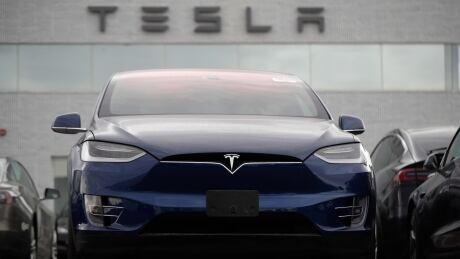 A Tesla 2019 Model X sits under a sign at a Tesla dealership in Littleton, Colo., Oct. 20. The company surprised investors by posting a profitable quarter. Earns Tesla