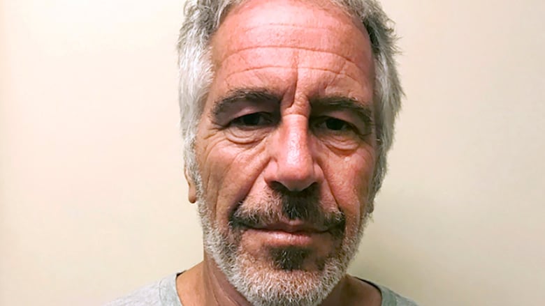 Mug shot of greying man in grey T-shirt.