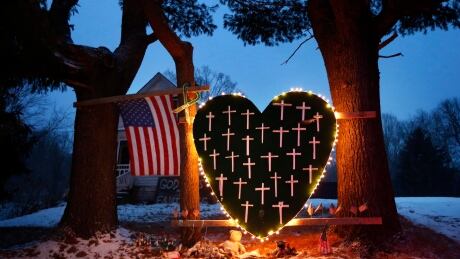 FILE - In this Saturday, Dec. 14, 2013, file photo, a makeshift memorial with crosses for the victims of the Sandy Hook massacre stands outside a home in Newtown, Conn., the one-year anniversary of the shootings. Connecticut authorities said they planned Friday, Dec. 27, 2013, to release state police documents from the investigation into last year's Newtown school massacre. Connecticut School Shootings