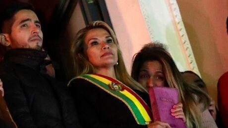Bolivian Senator Jeanine Anez gestures after she declared herself as Interim President of Bolivia, at the balcony of the Presidential Palace, in La Paz, Bolivia November 12, 2019. BOLIVIA-ELECTION/